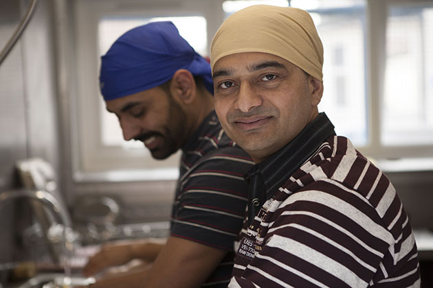 Men washing up in a large kitchen