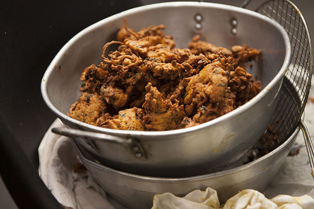 Deep fried pakora in a stainless steel pan