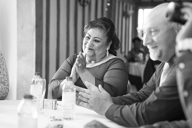 Wedding guests sitting at a table clapping