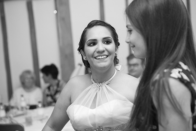 Candid photo of bride talking to a wedding guest