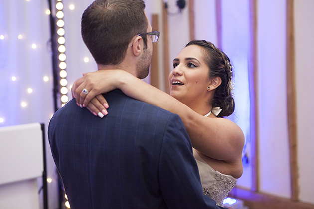 Bride with her arms around groom during their first dance at Vaulty Manor