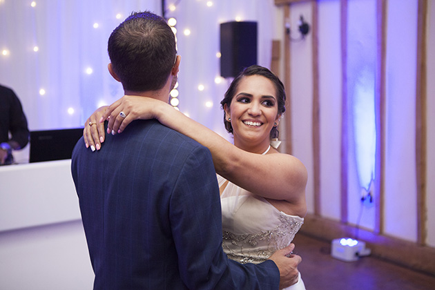 Bride with her arms around groom during their first dance at Vaulty Manor