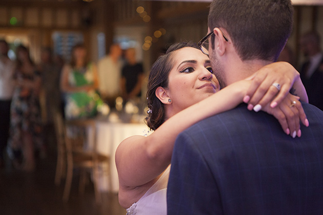 Bride with her arms around groom during their first dance at Vaulty Manor