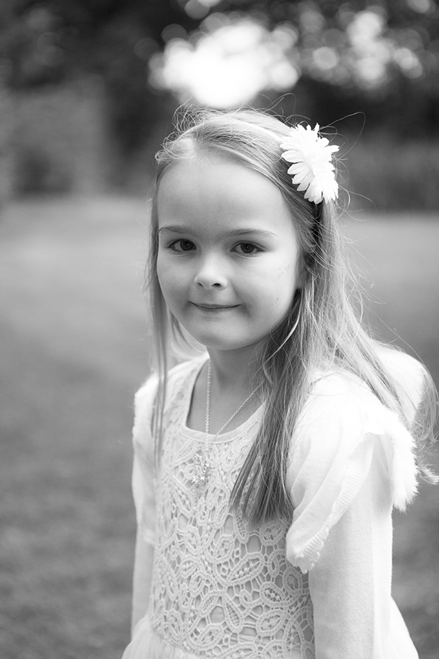 Black and white portrait of young girl in formal gardens