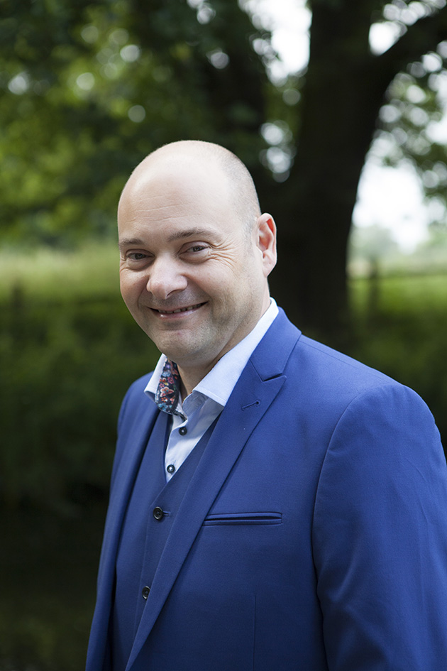 Natural portrait of groom wearing a blue suit