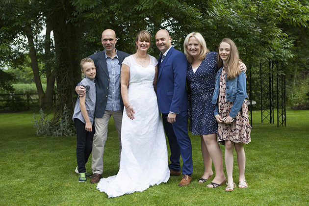 relaxed family group photo in garden of hotel