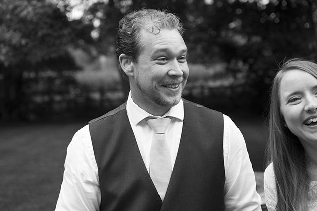 Candid photo of man in waistcoat at a wedding celebration