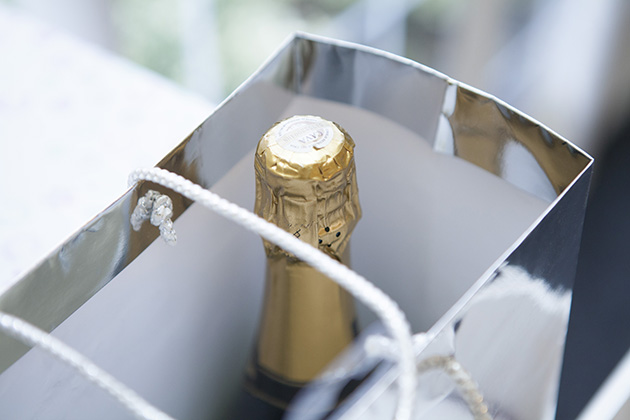 Close-up of top of champagne bottle in a gift bag