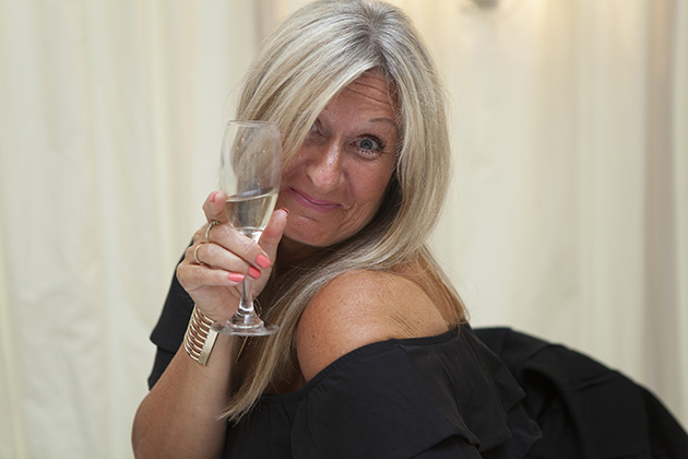 Woman raising a champagne glass to the camera