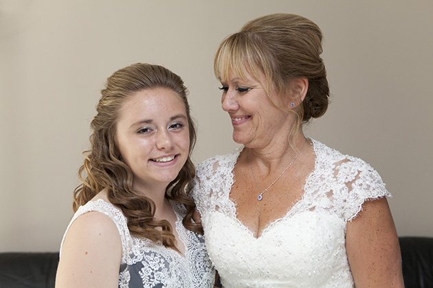 Portrait of bride looking at her teenage daughter