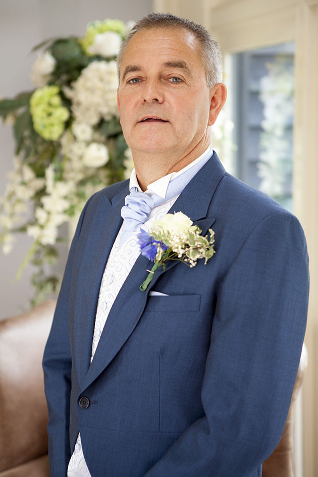 Portrait of groom in foyer of wedding venue