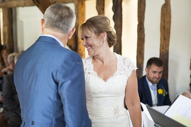 Bride standing with groom and looking back