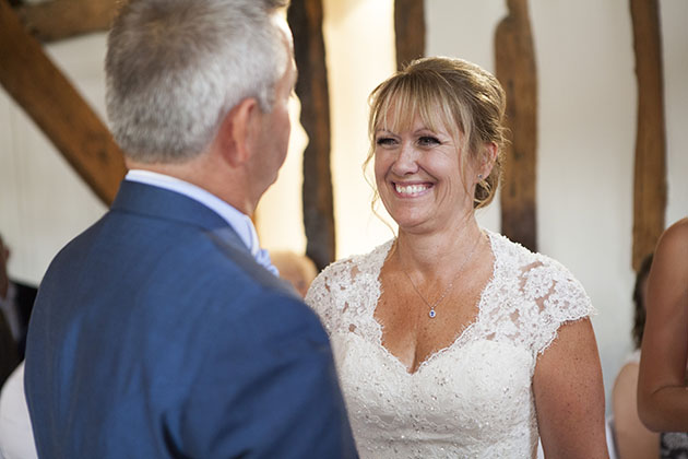 Bride smiling at groom during wedding ceremony