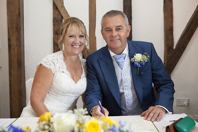 Bride and groom signing register at Little Channels