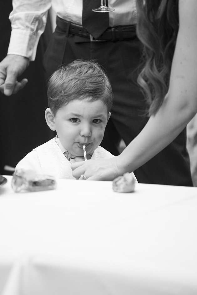 Toddler page boy drinking from a straw
