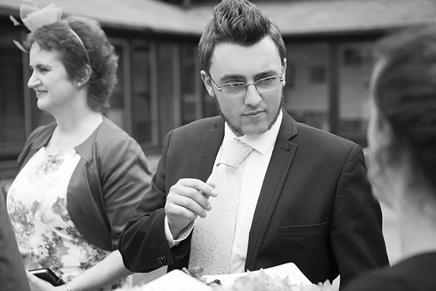 Candid photo of wedding guest taking a canape