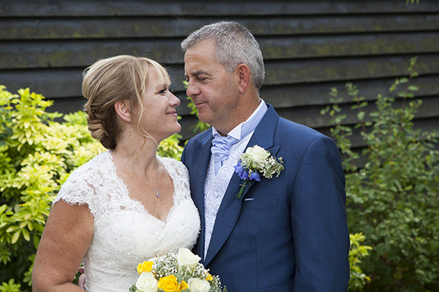 Portrait of bride and groom looking at each other in garden at Little Channels