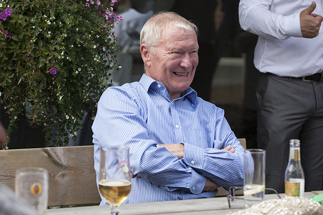 Candid photo of wedding guest siting at table with drinks