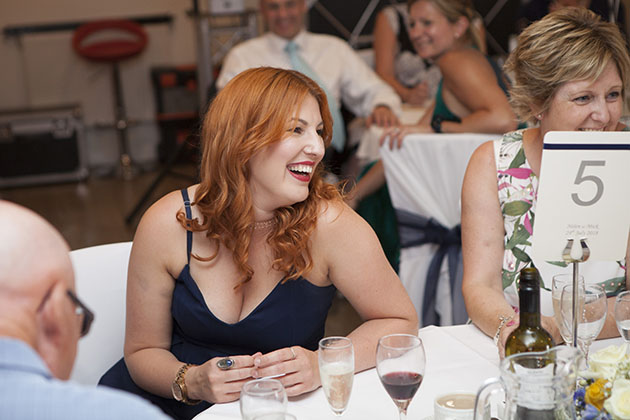 Wedding guest laughing at a table