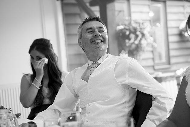 Best man on top table looking up at groom making the speech