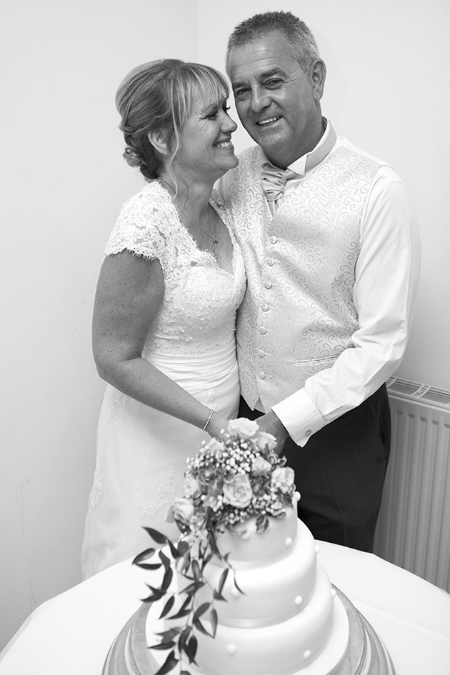 Bride and groom cutting wedding cake