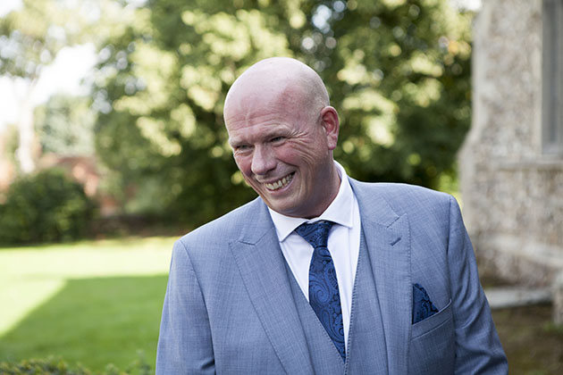 Candid portrait of best man outside church