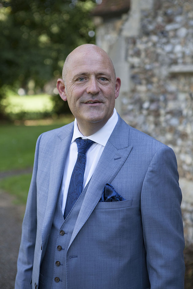 Portrait of groom outside church