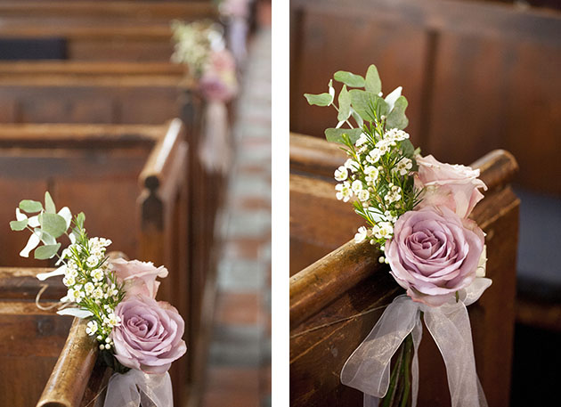 Details of flowers at end of pews in empty church