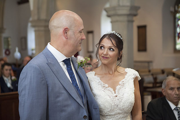 Bride looking at groom during wedding ceremony