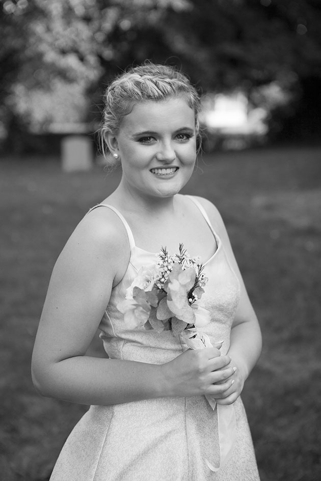 Black and white portrait of young woman in church garden