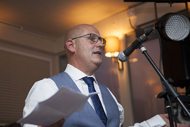 Groom making wedding speech at a microphone