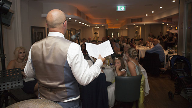 Rear view of groom making wedding speech