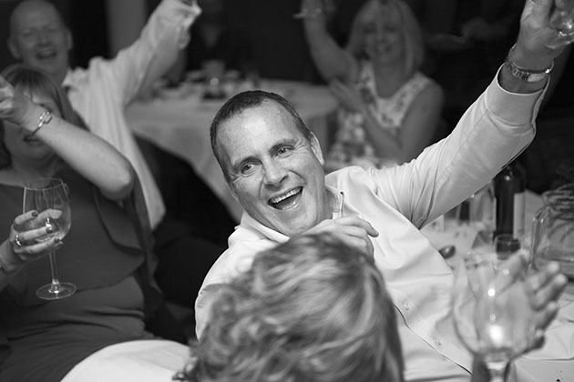 Wedding guests raising drinking glasses