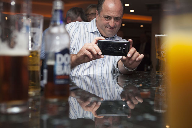 Wedding guest taking a photograph at the bar